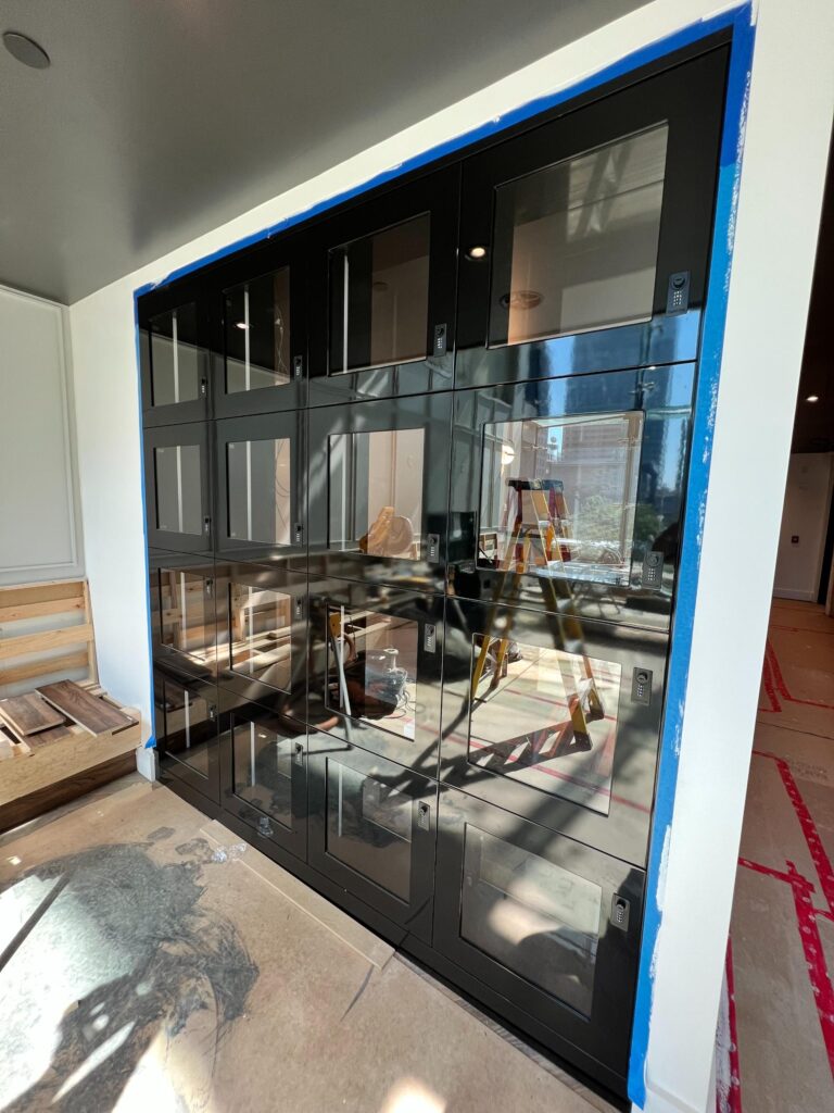 Black-framed glass partition wall being installed in an office