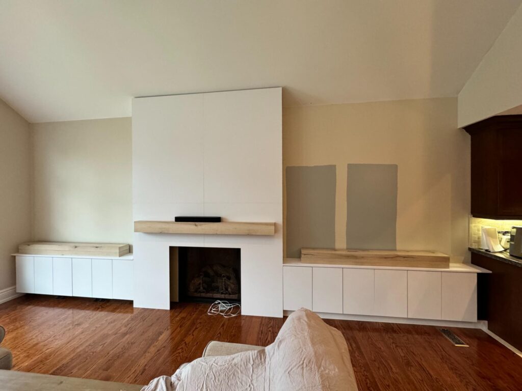 Fireplace wall with built-in white cabinets during finishing