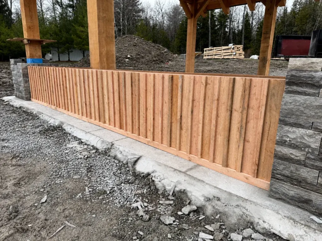 Vertical cedar cladding on an outdoor kitchen base during construction